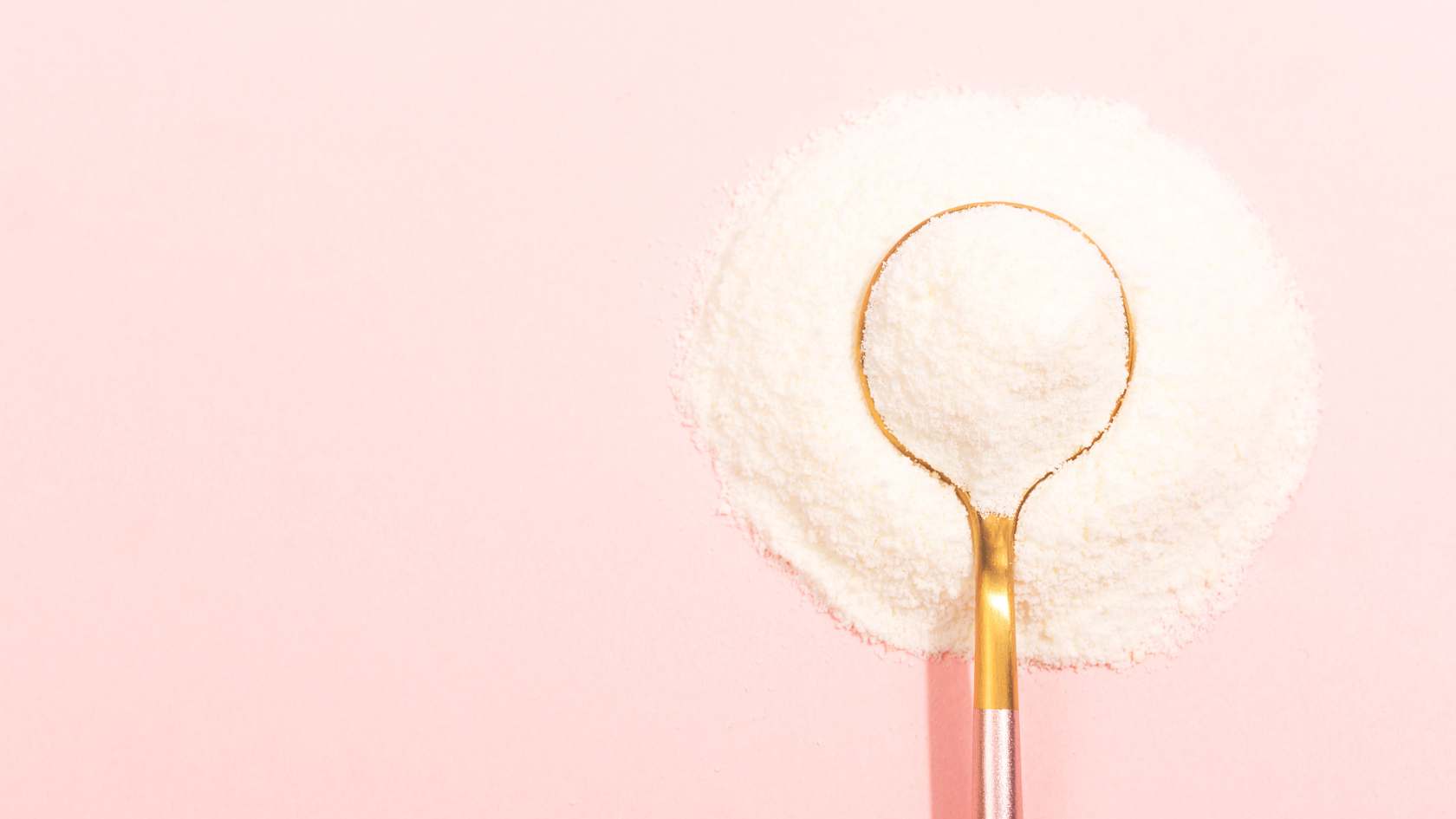 A gold spoon in a pile of powdered collagen