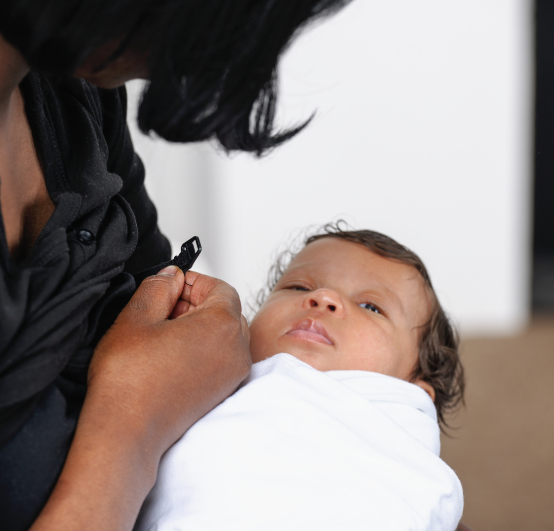 mom unclipping nursing bra to feed baby