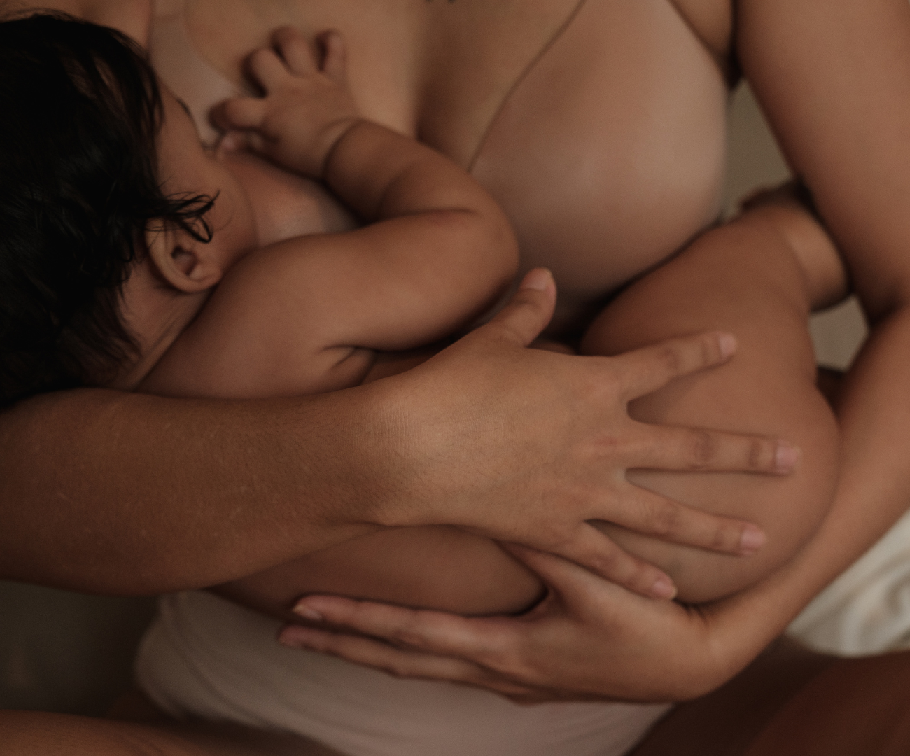 New mom holding baby while nursing.