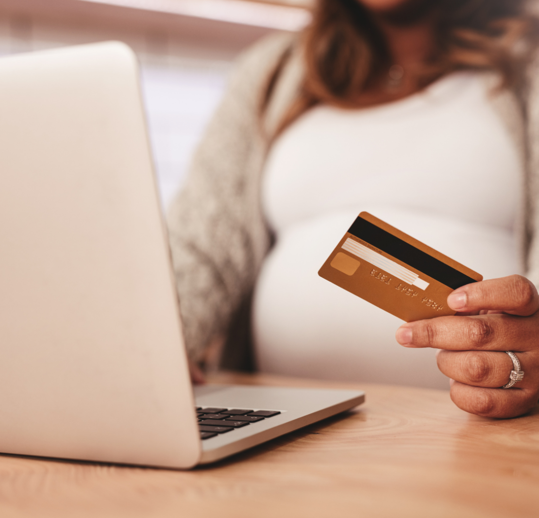 pregnant mom shopping for postpartum items on her laptop